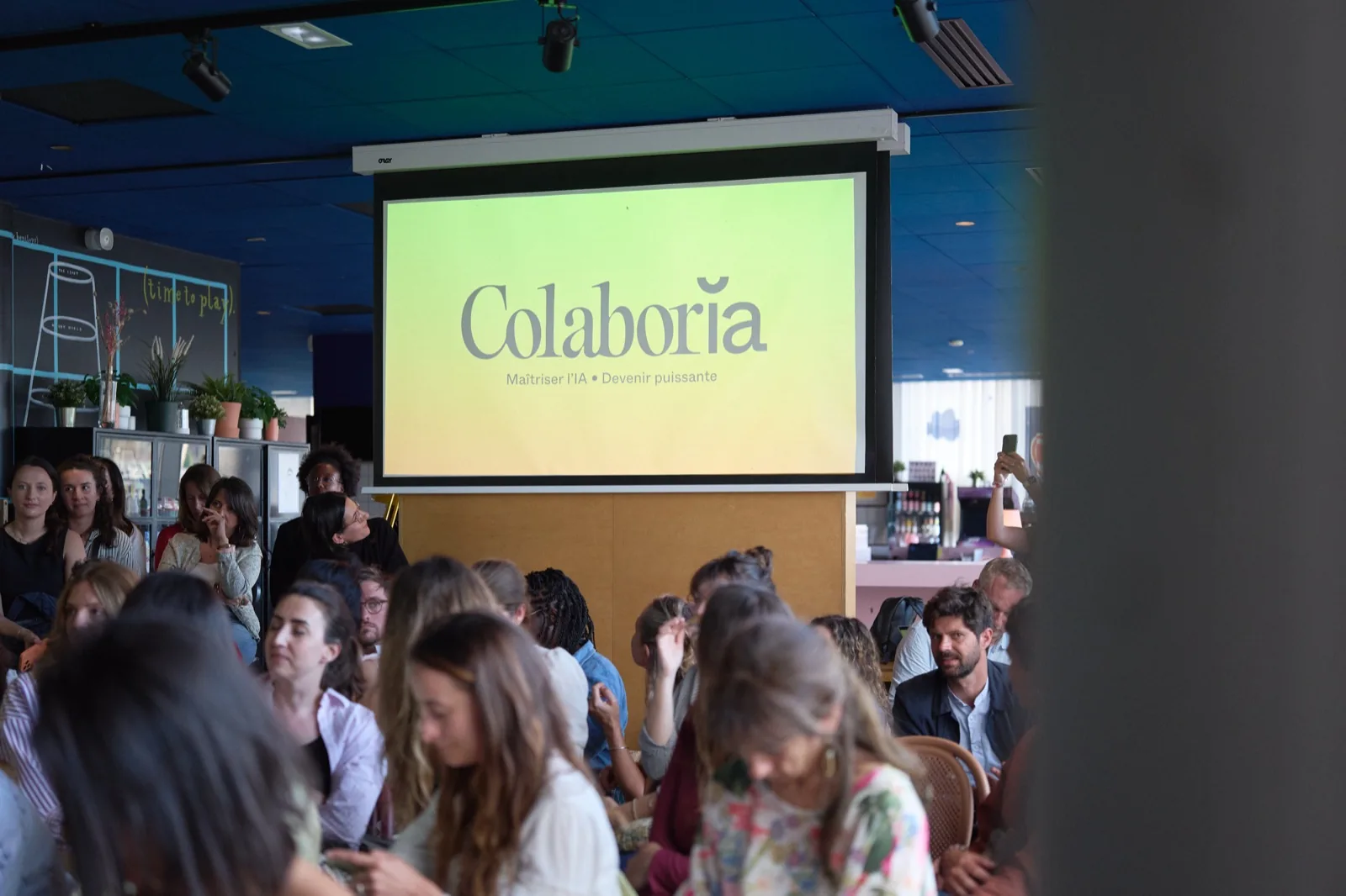 Un événement Femmes & IA de Colaboria : le public face à l'écran de la conférence